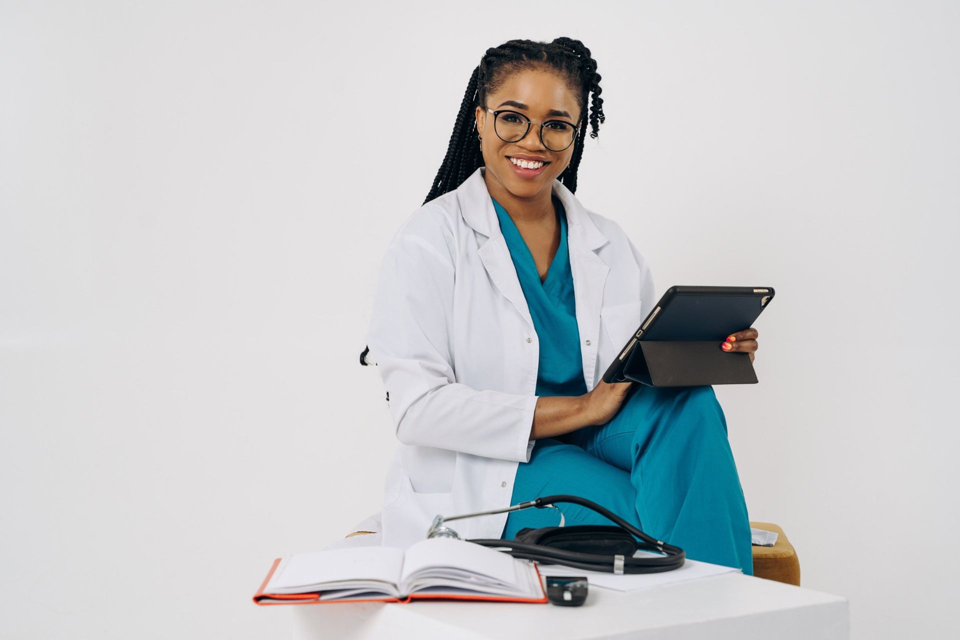 A smiling physician holding a tablet, ready to help
